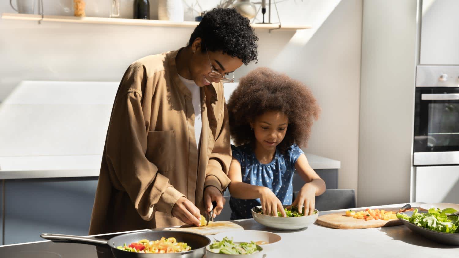 Mother and daughter cooking together
