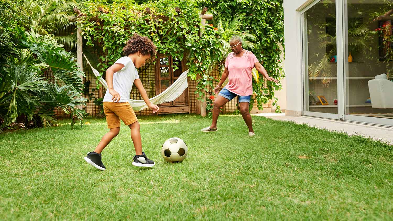 Grandmother and child playing soccer