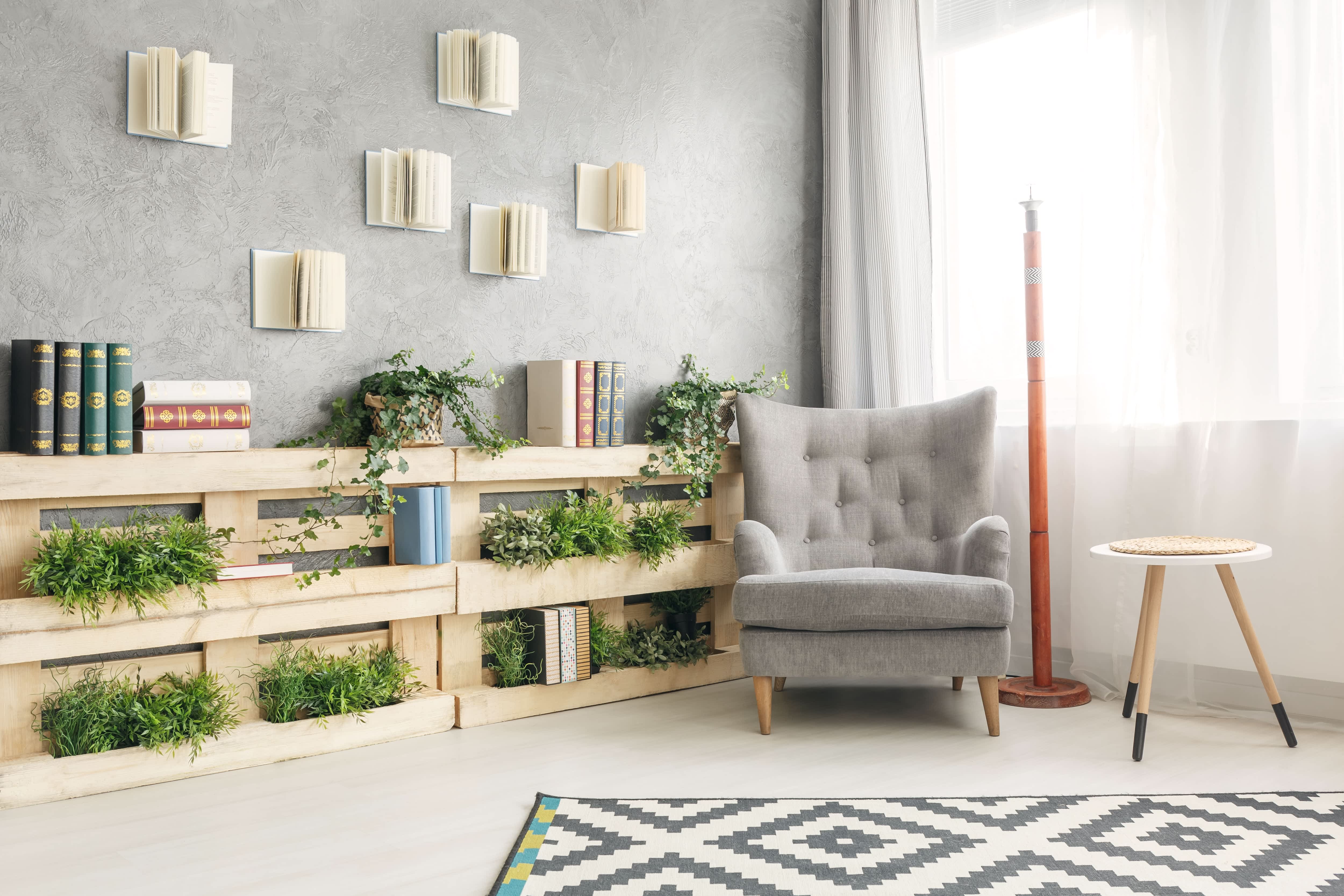 Book nook with tufted armchair and houseplants