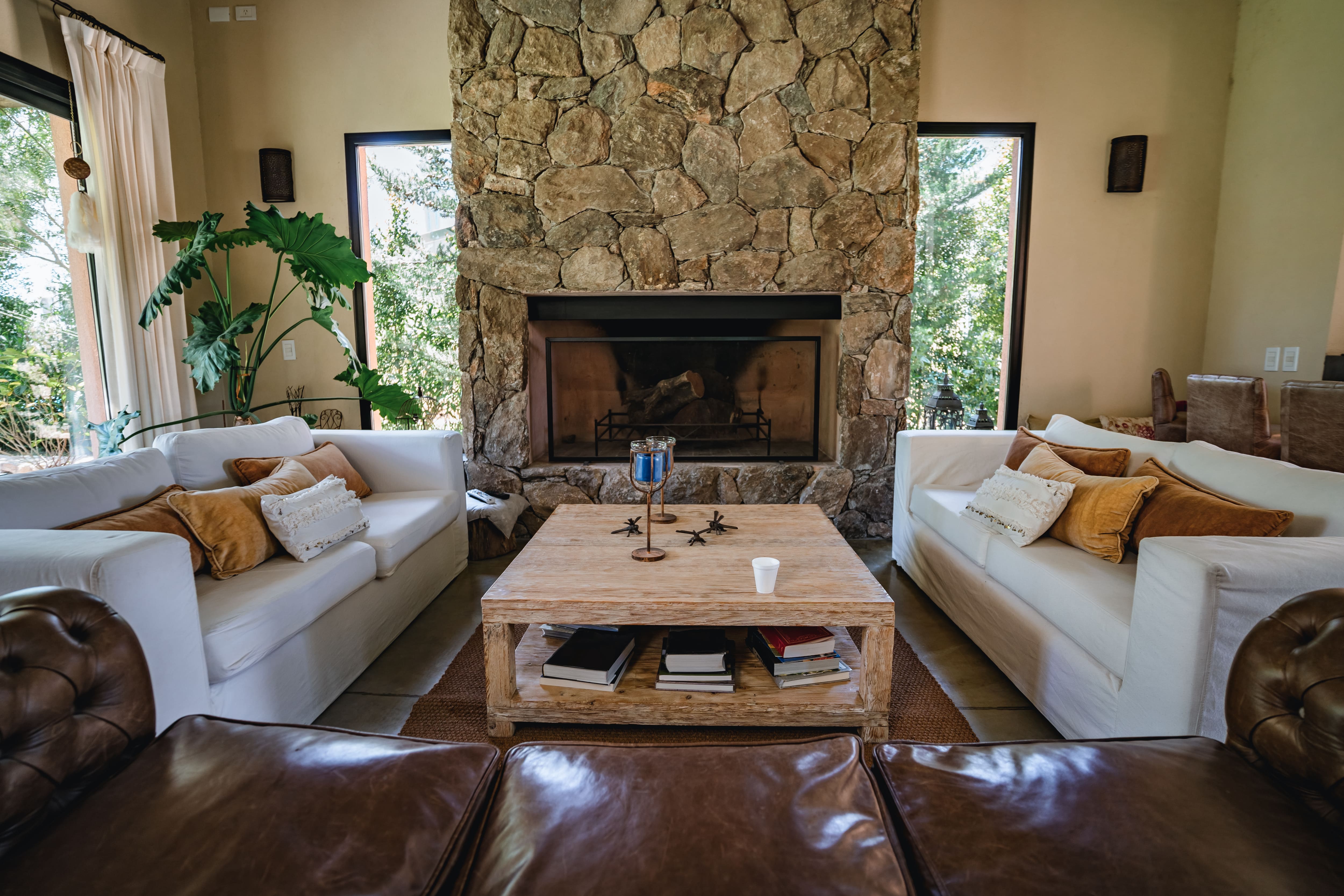 Living room with stone fireplace and leather sofa