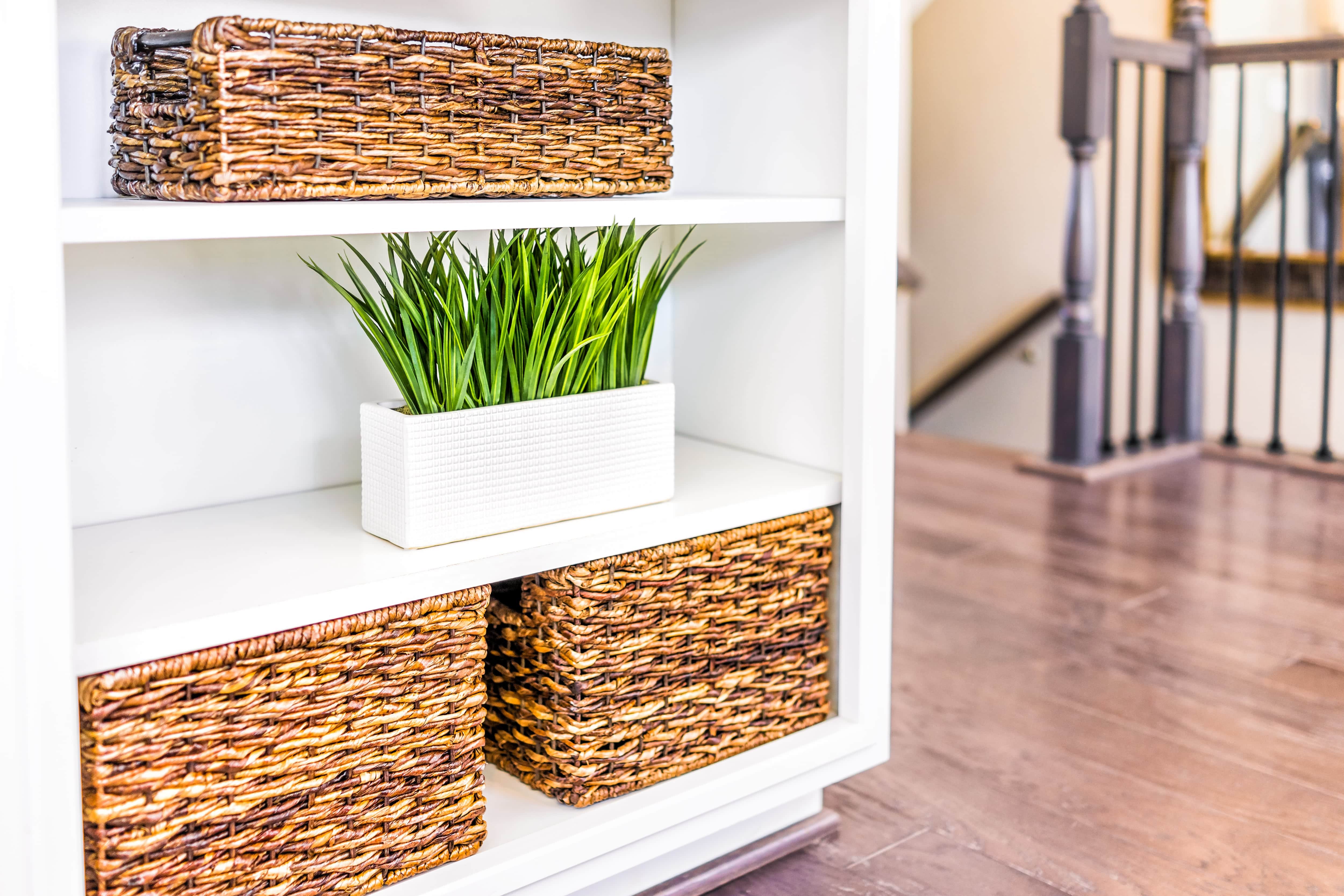 Woven storage baskets in white cabinetry