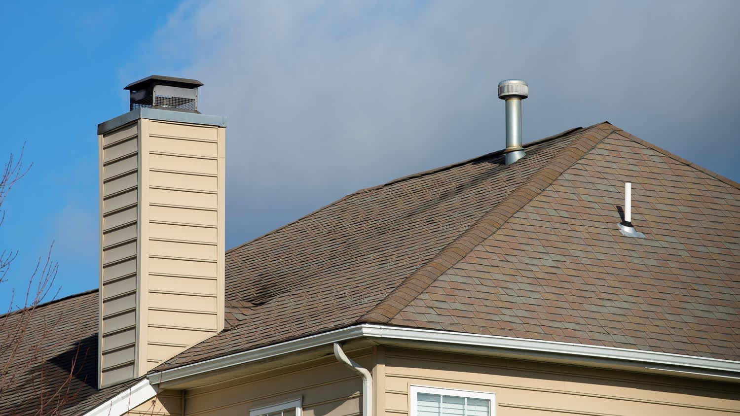 A galvanised metal chimney with a rain cap