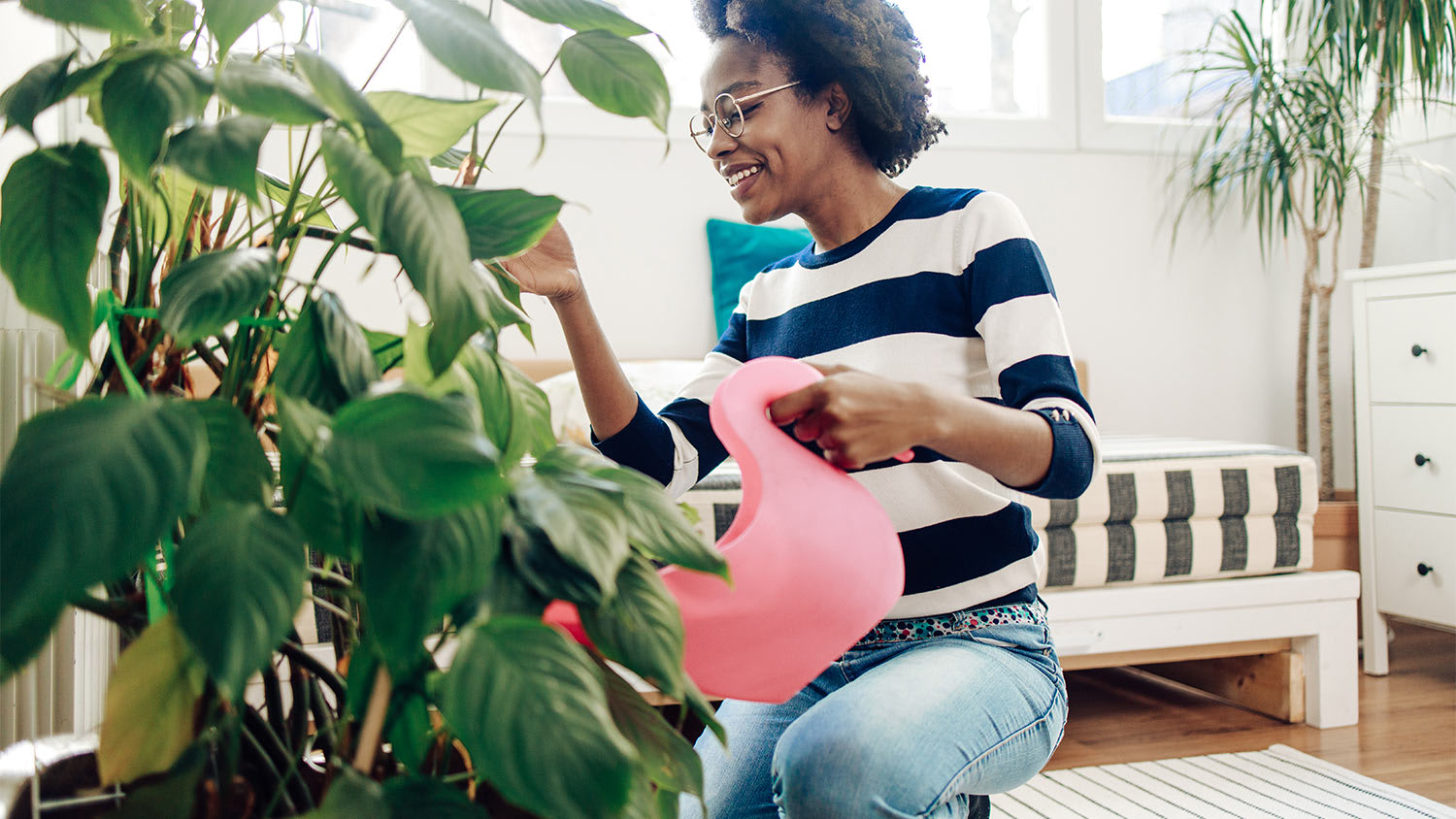 Woman home water plants watering can