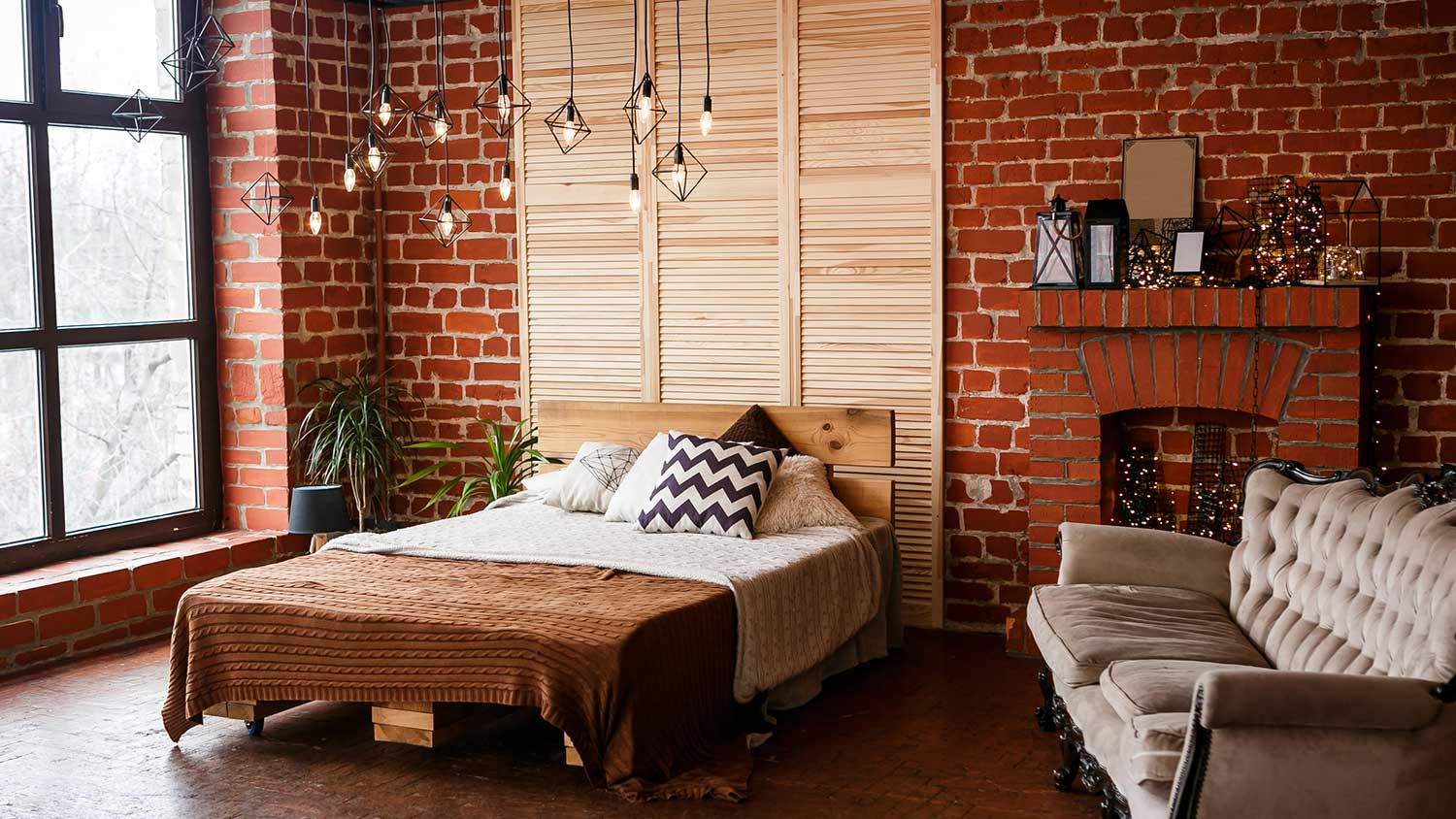 Bedroom with brick wall and fireplace