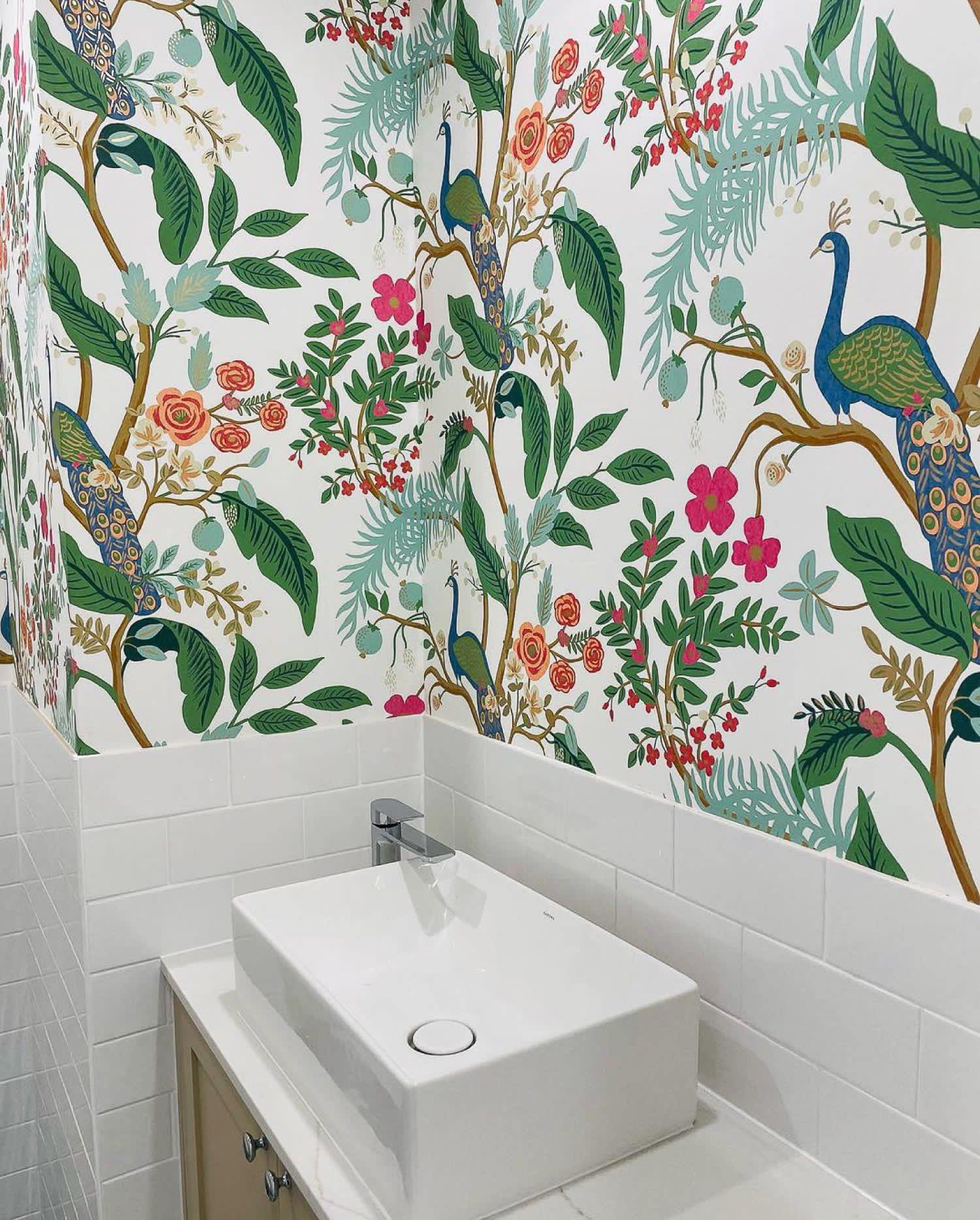 A kid’s bathroom with peacock wallpaper