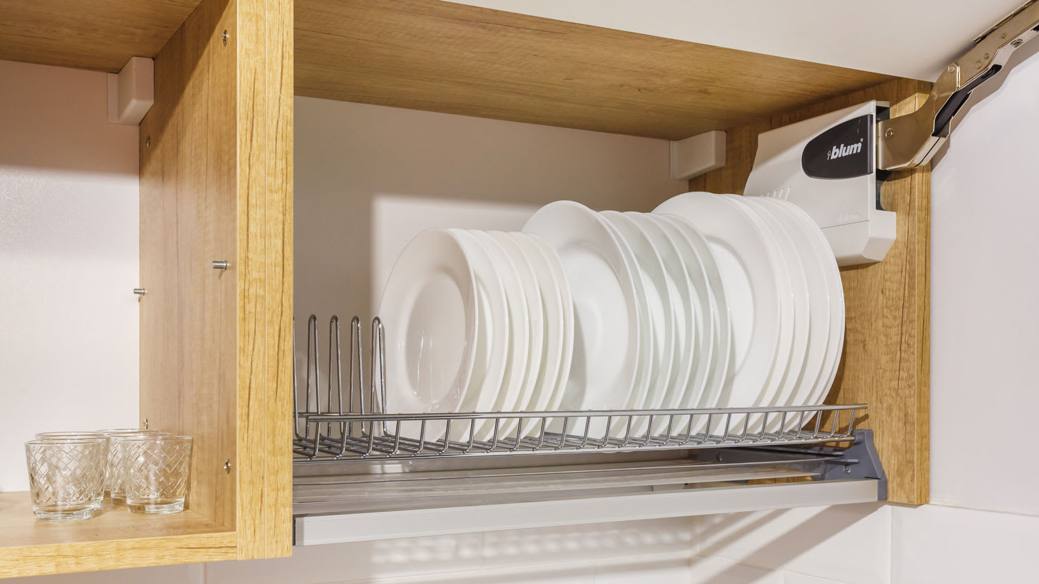 A plate rack inside a wooden cabinet