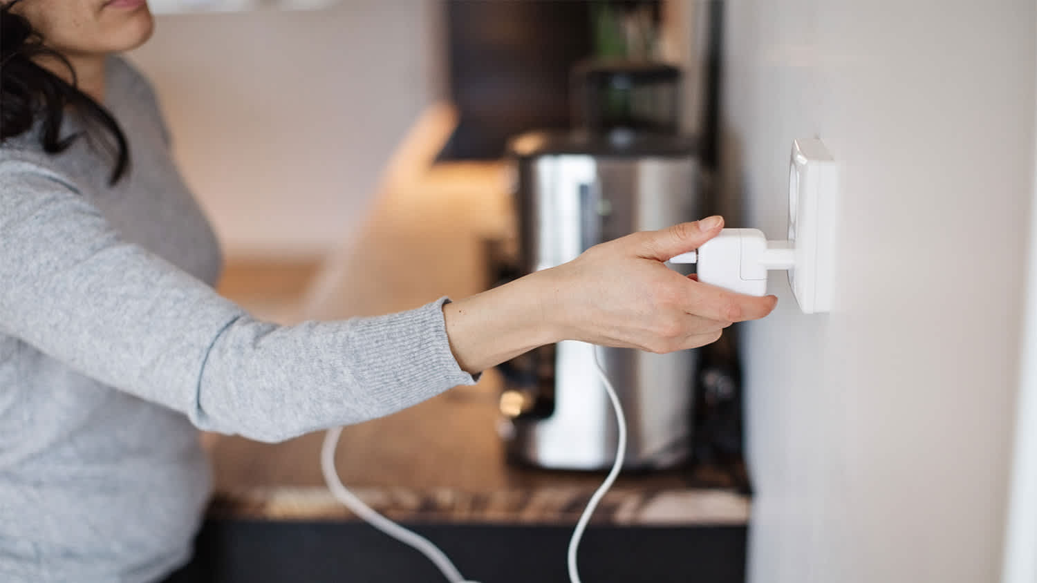woman charging her phone in outlet