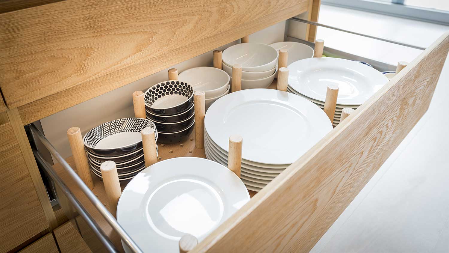 Open kitchen drawer with plates and dividers