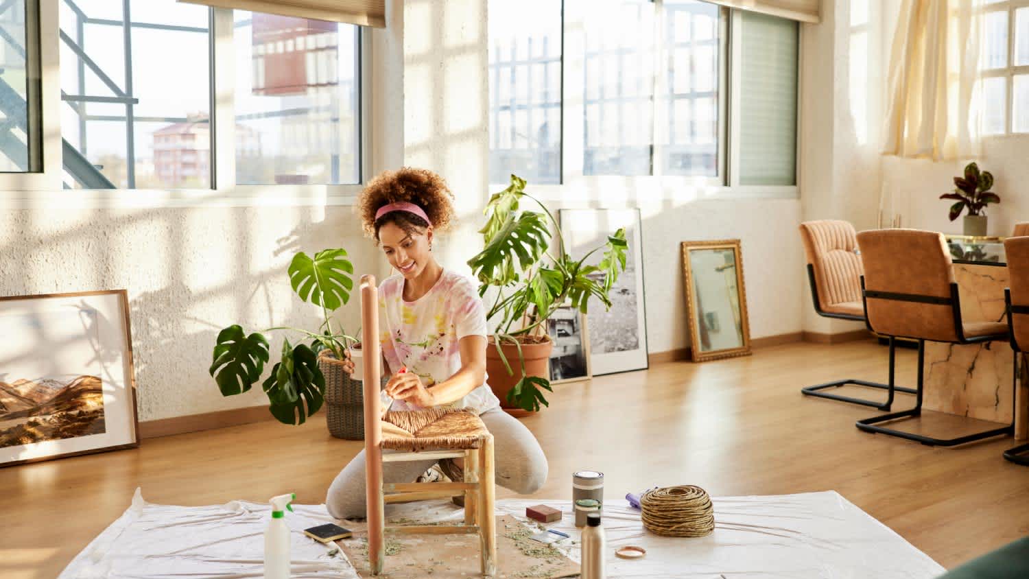 A woman painting chair at home