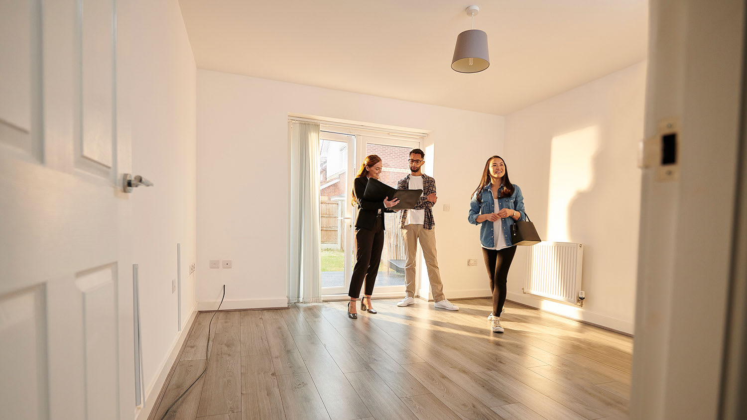 Real estate agent showing apartment to a couple