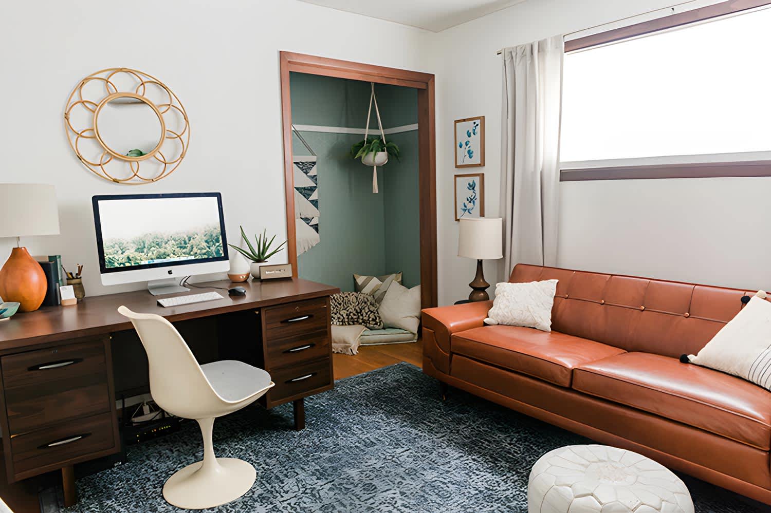 A wooden desk and a sofa creating a nook