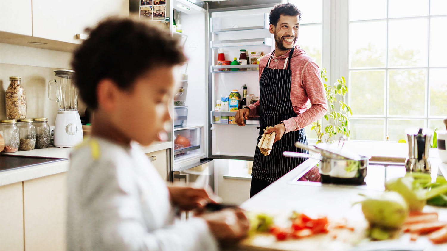 Man and boy kitchen prep food refrigerator