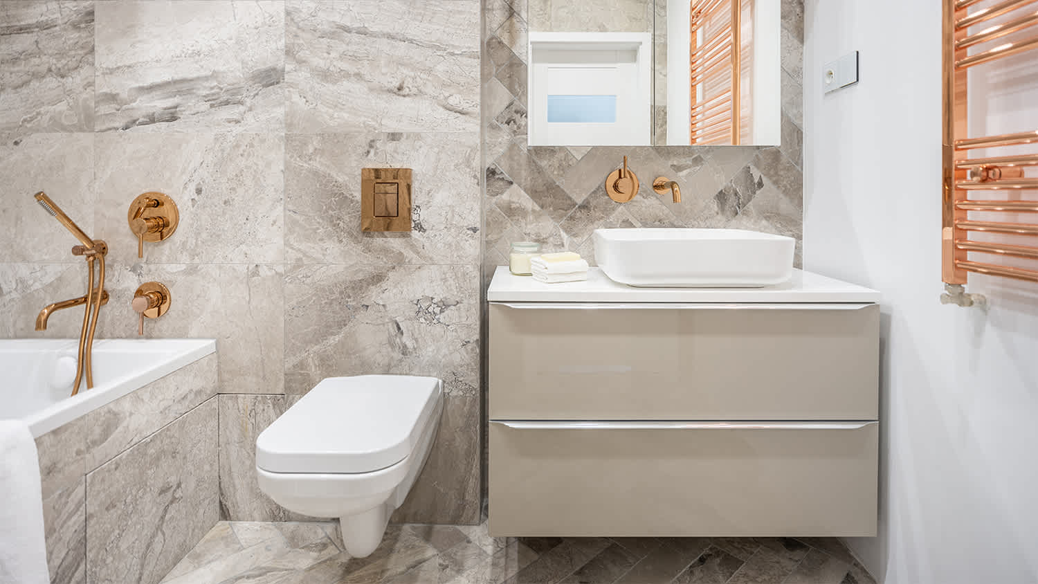 marble bathroom with gold hardware