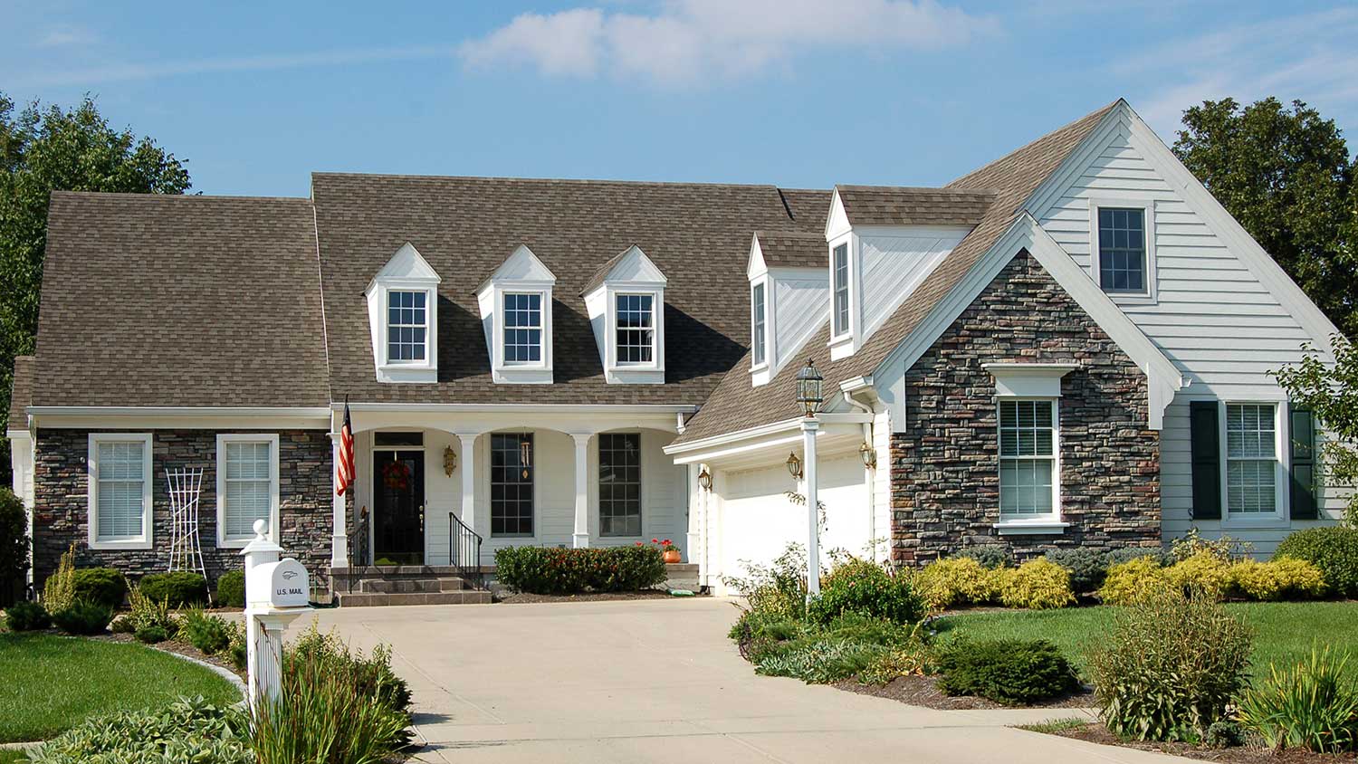 Big suburban home with stone siding