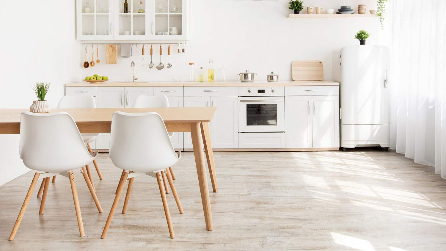 A Scandinavian kitchen with shelves and a wooden table