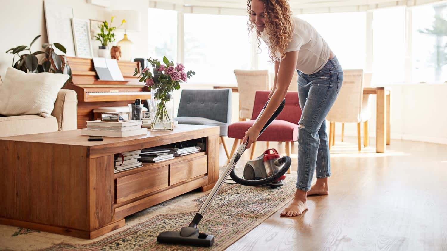 A woman vacuuming in the living room