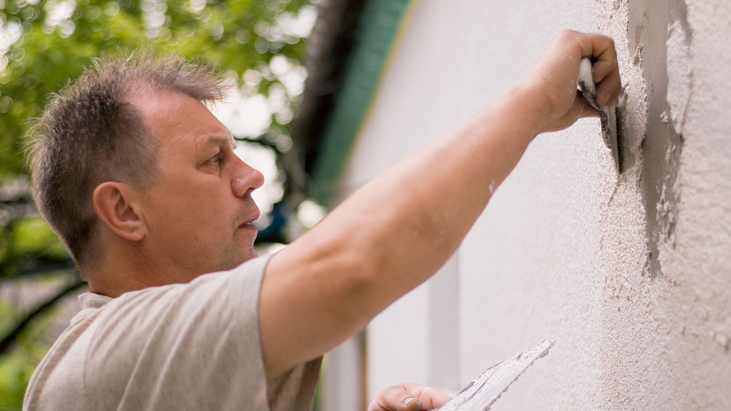 Worker repairing exterior wall