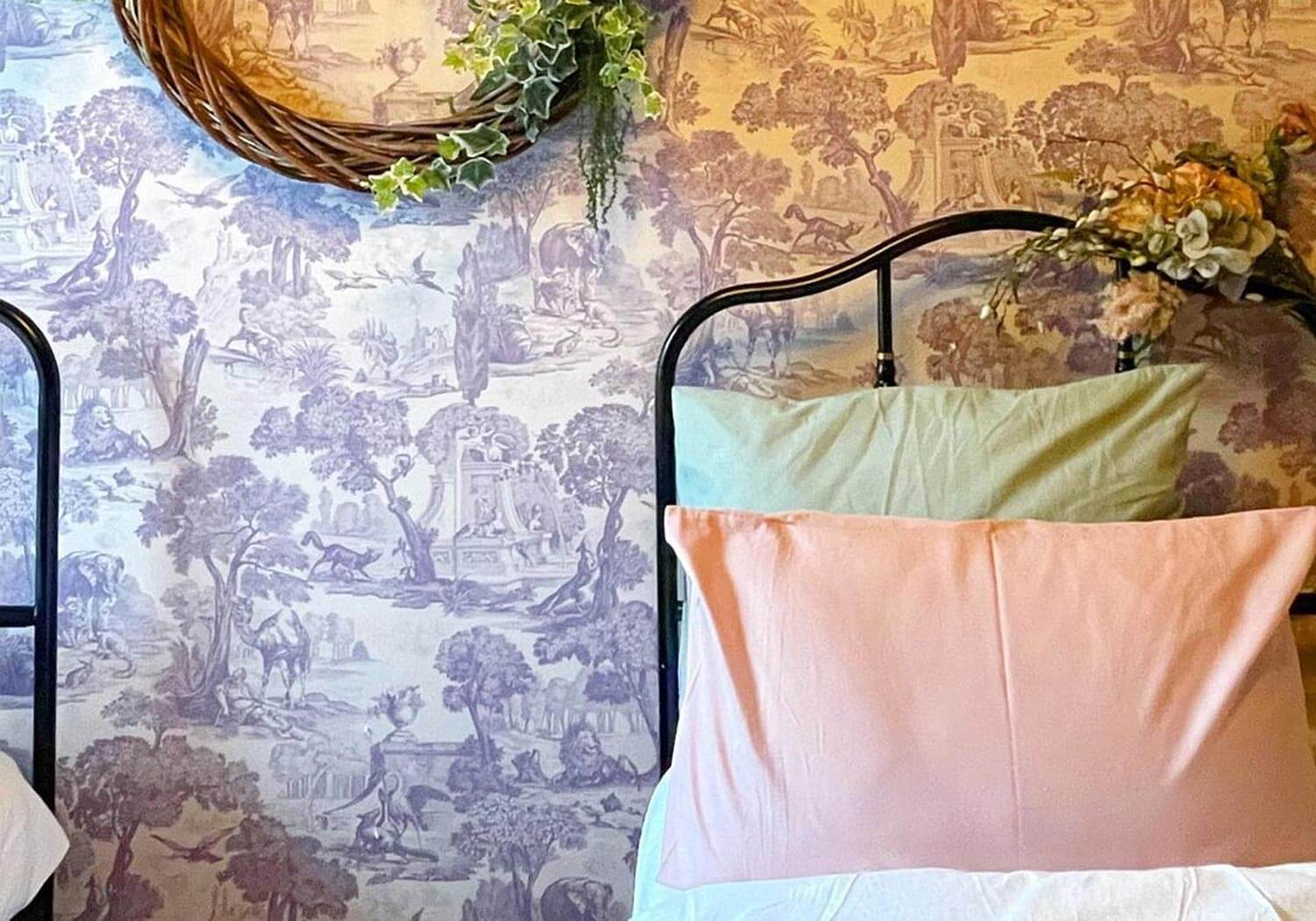 A floral wallpaper in a bedroom