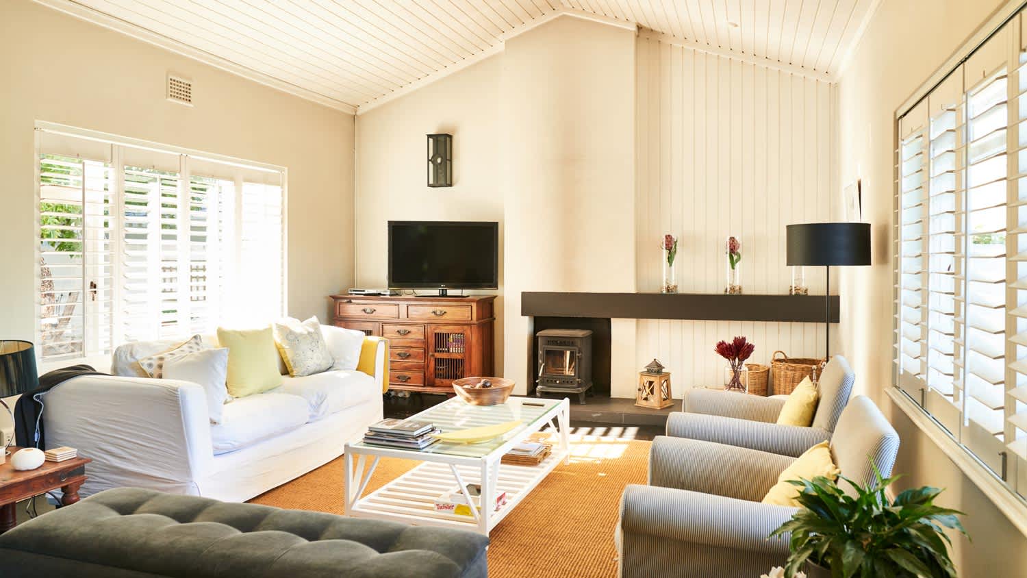 A living room with a wooden vaulted ceiling