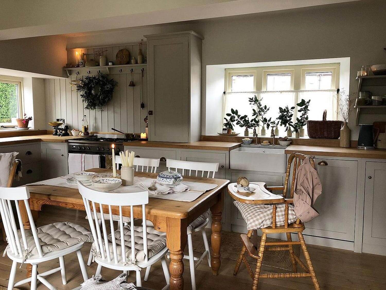 A cottage kitchen with a wooden dining table and chairs