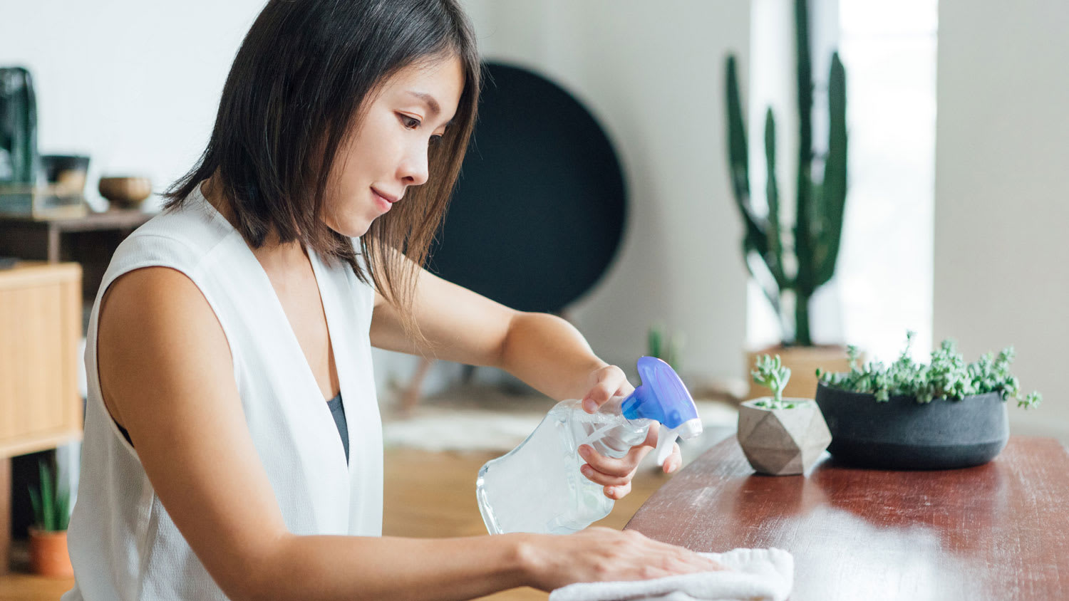 A woman spraying a surface