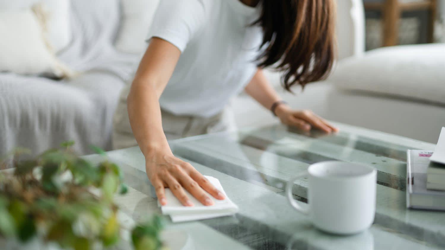 A woman tidying up the living room