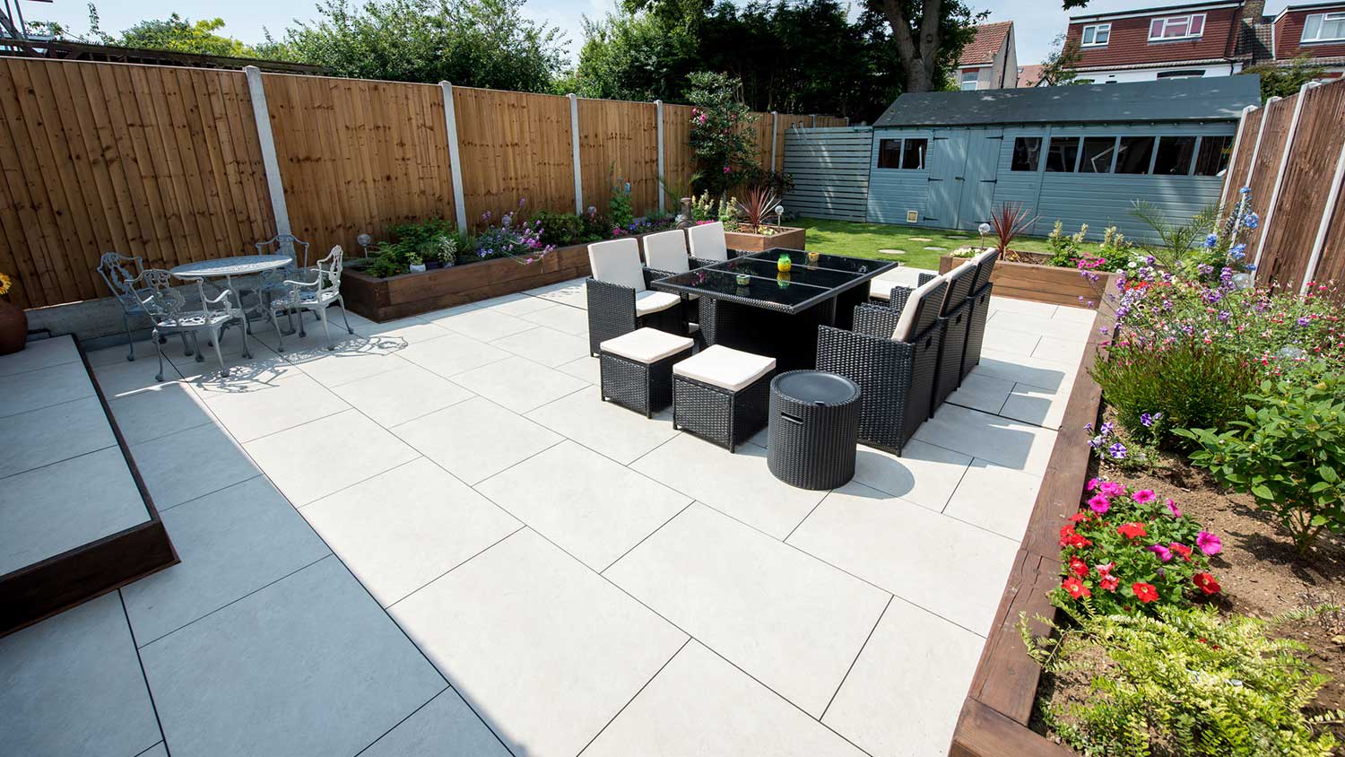 Backyard patio with porcelain pavers and outdoor furniture