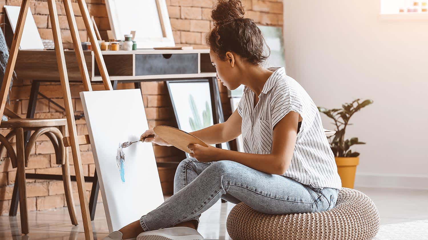 Woman painting easel floor pillow