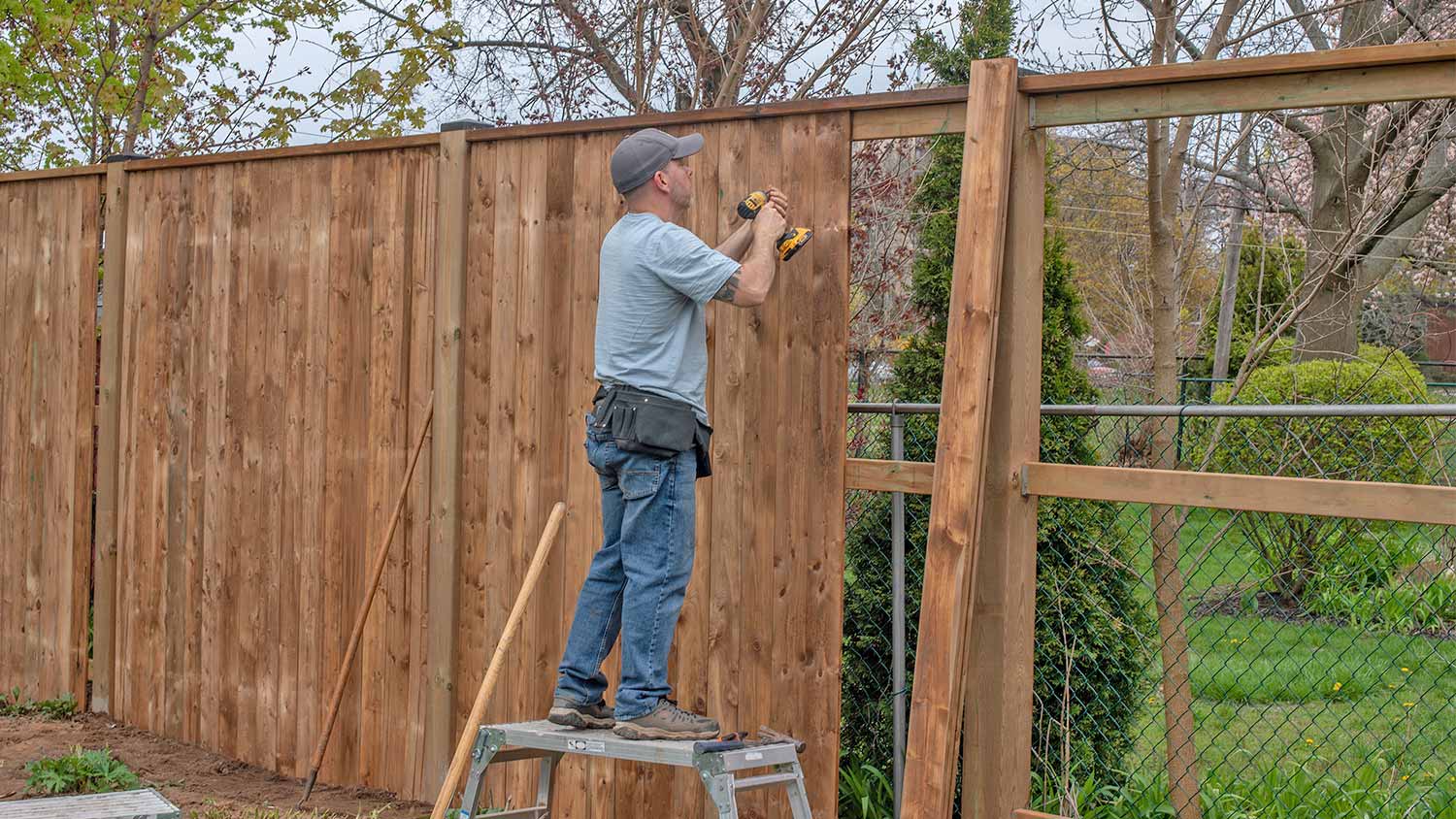 Man building fence in yard