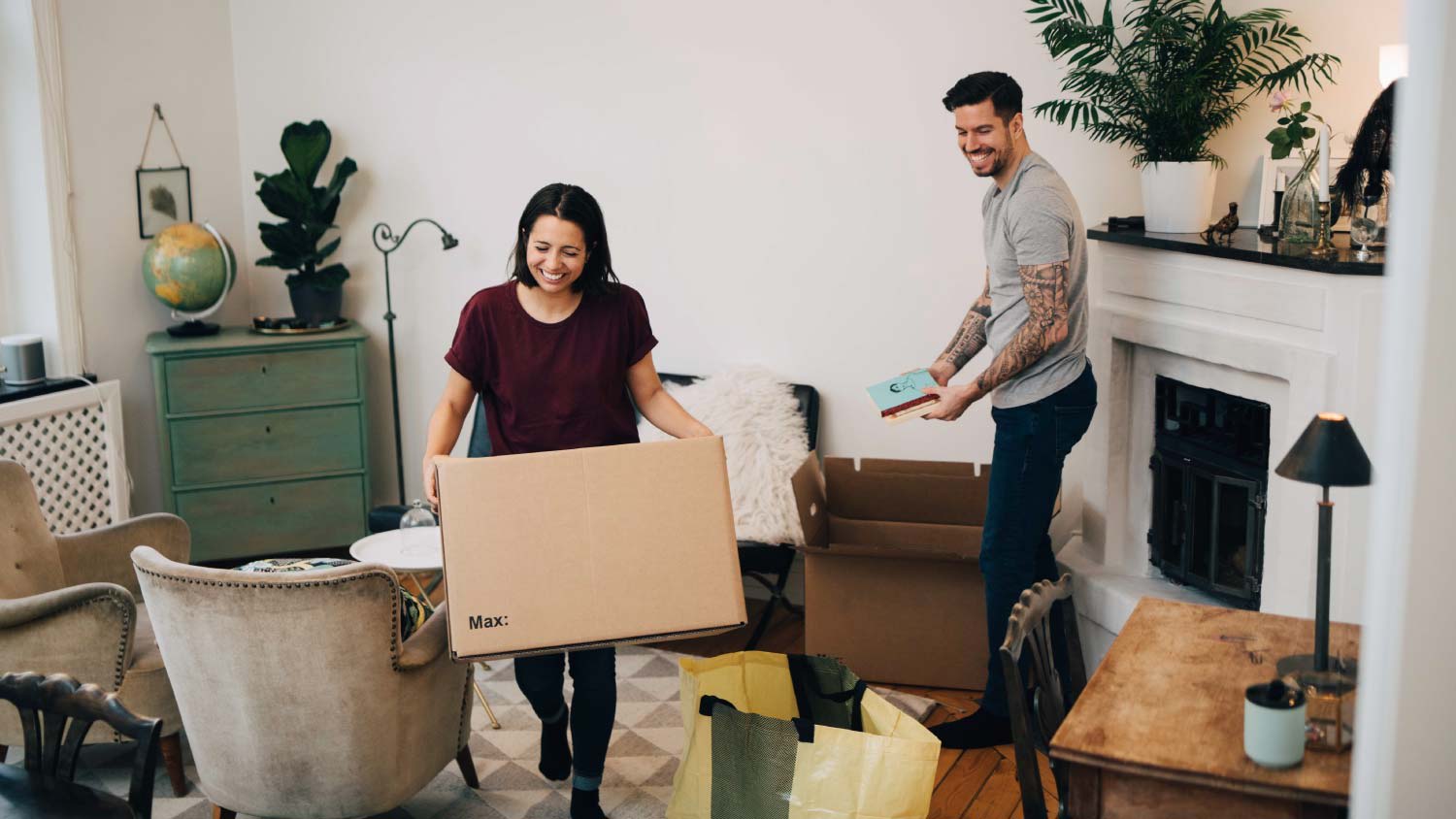 Couple unpacks moving boxes at new home