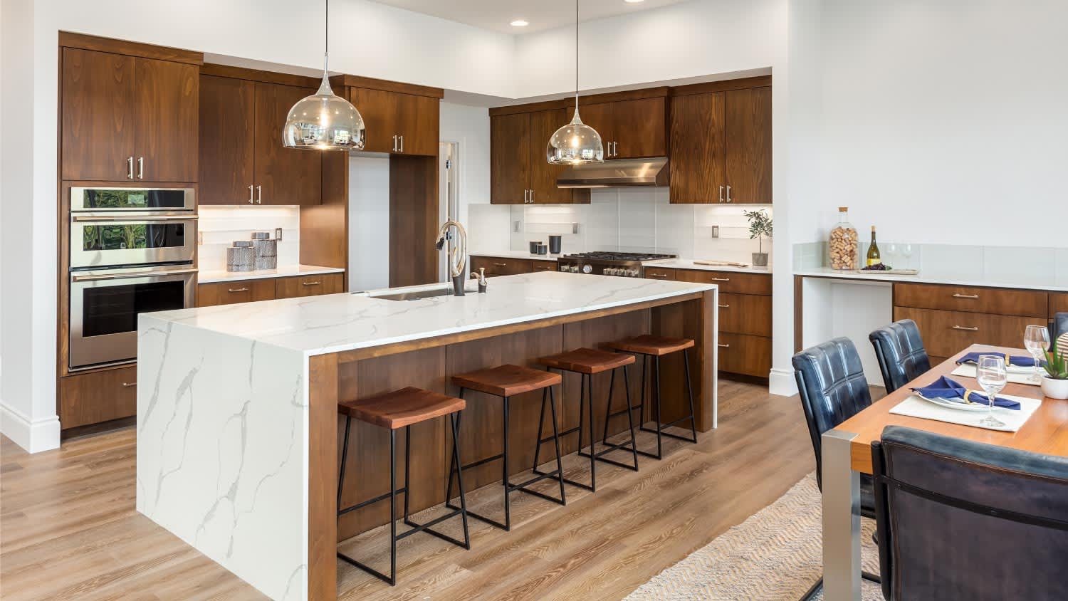 A luxury kitchen with a quartz waterfall island