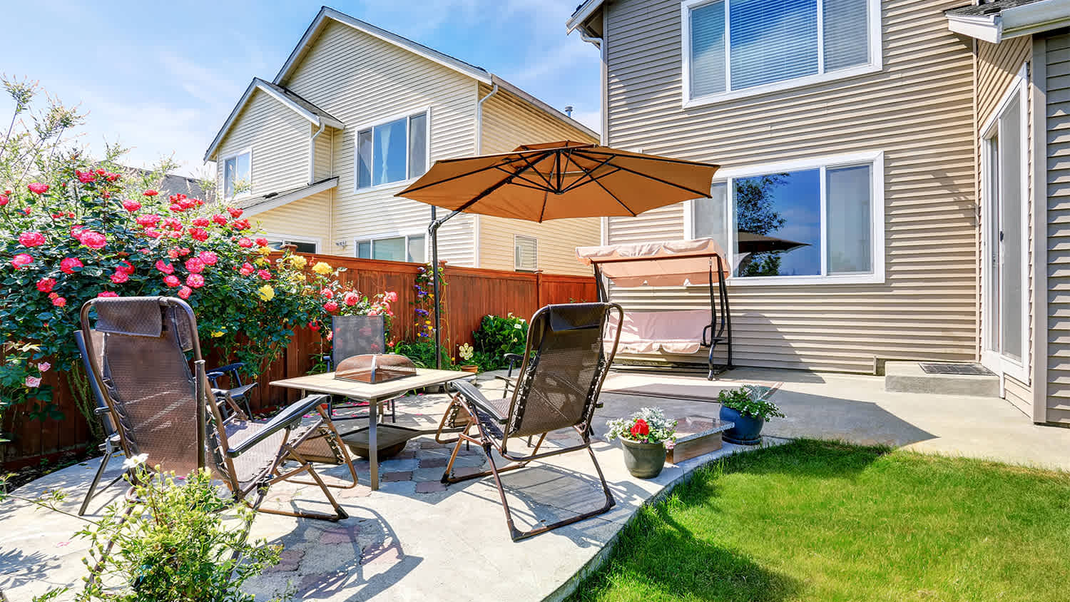 patio with folding chairs and  umbrella