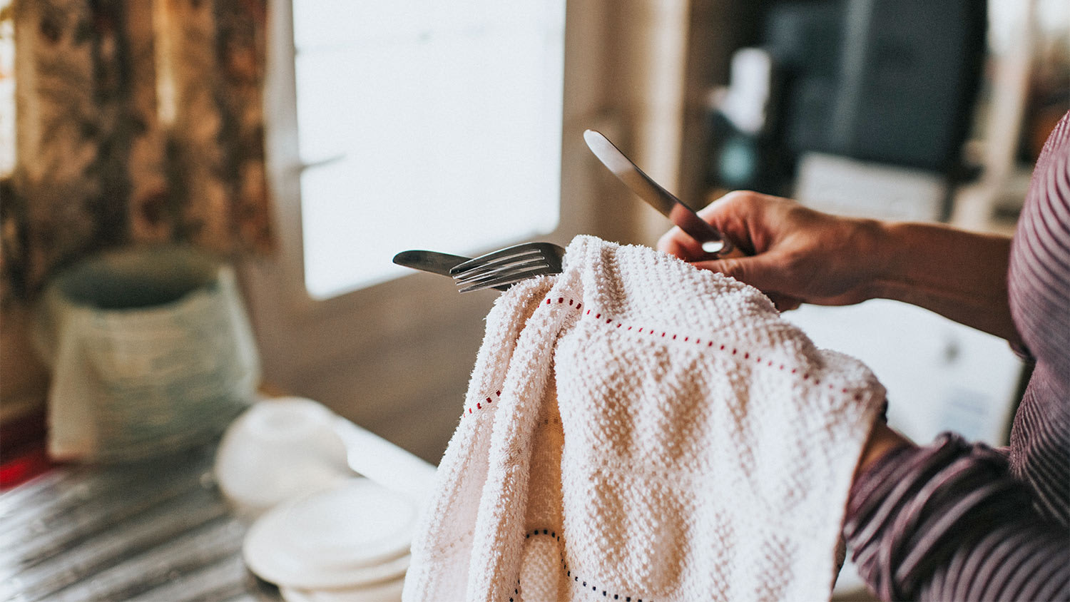Hands clean silverware kitchen