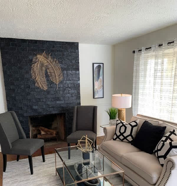 Stylish living room with black brick fireplace