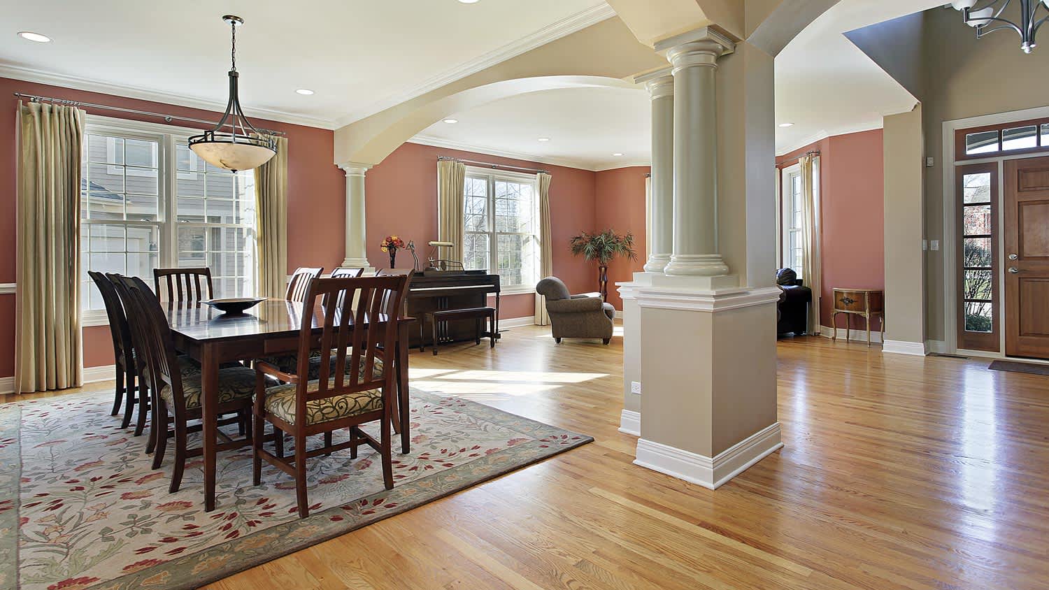 A traditional open floor living room with terracotta painted walls