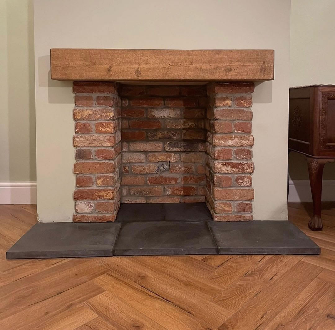 brick fireplace with oak mantel