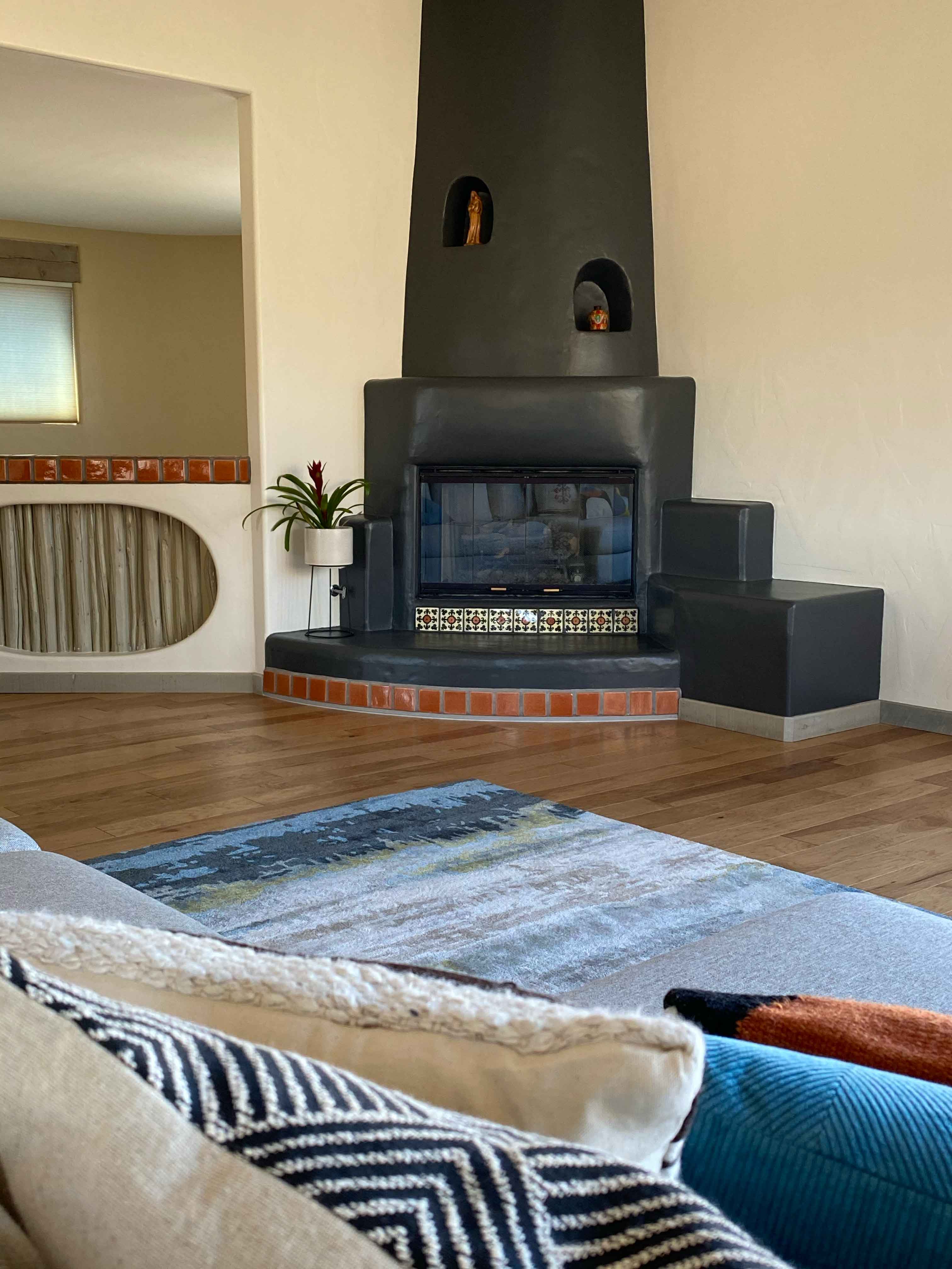 Home interior with adobe fireplace