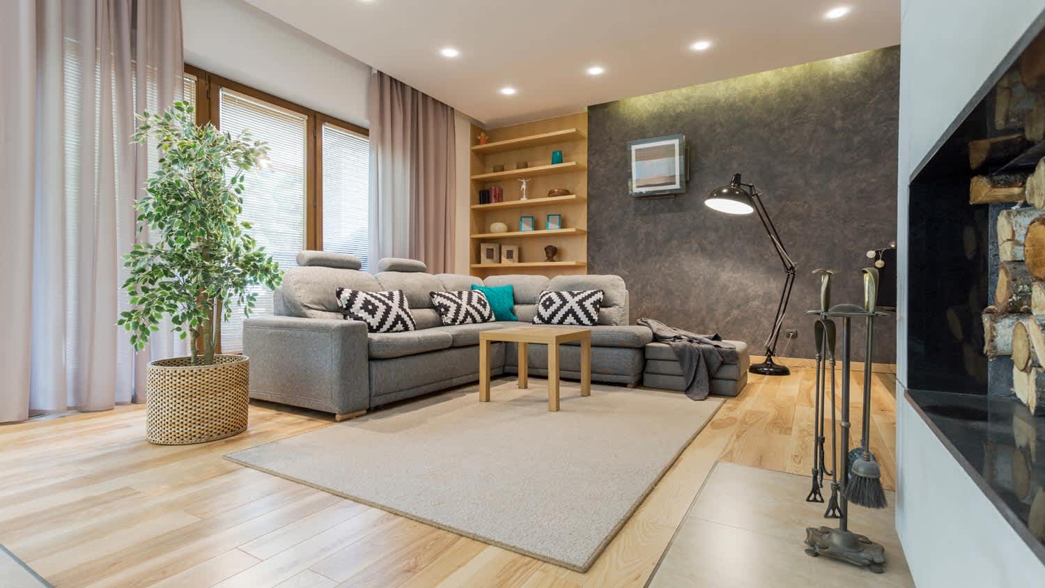 A living room with drop ceiling and recessed lighting