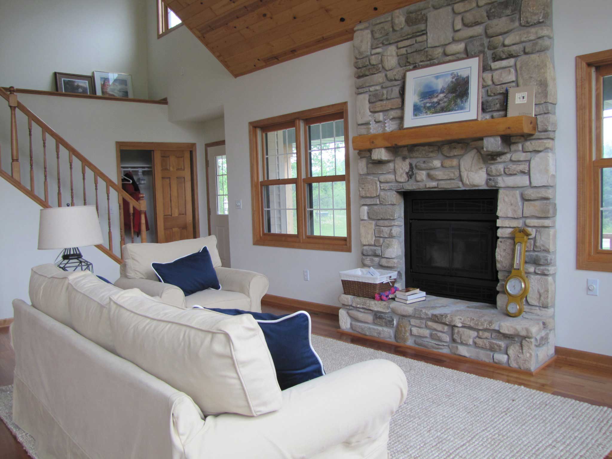 Stone fireplace with wooden mantel in a living room