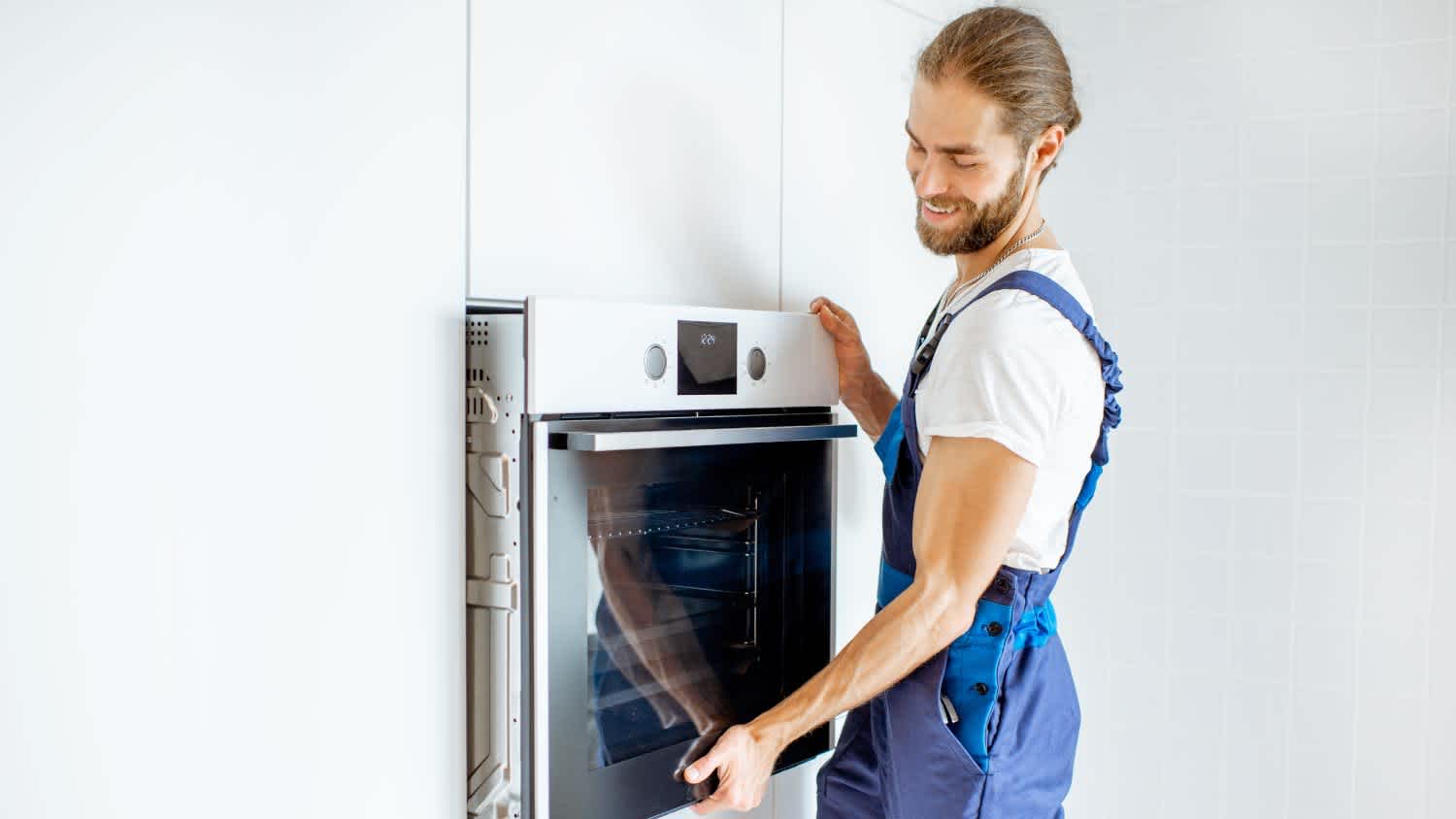 Worker installing electric oven
