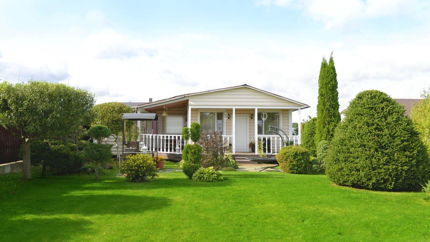 A backyard of a house with a landscaped garden with shrubs
