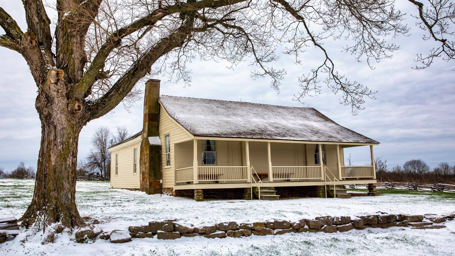 The exterior of a brown historic house during winter time