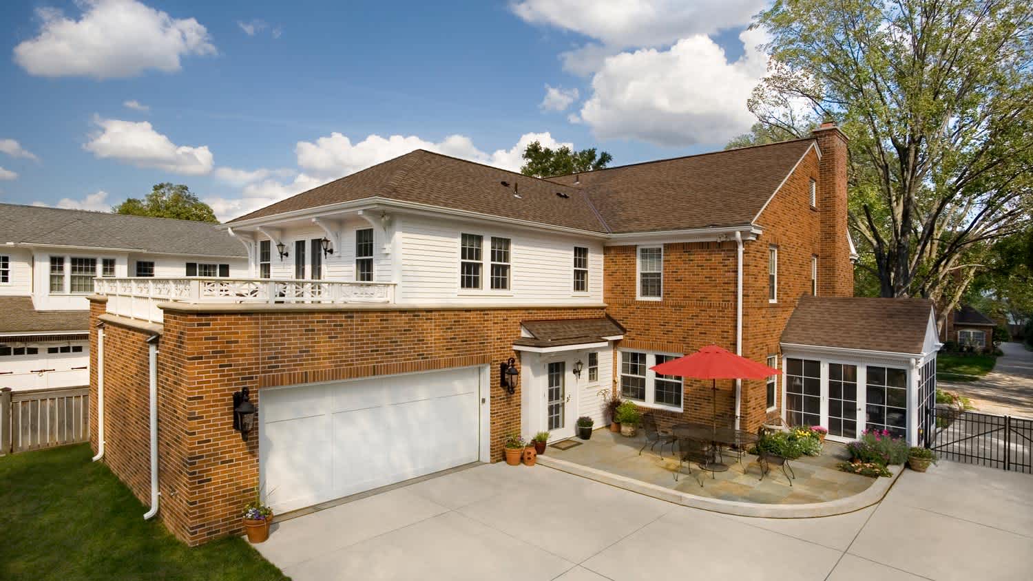 A traditional brick house with a big garage
