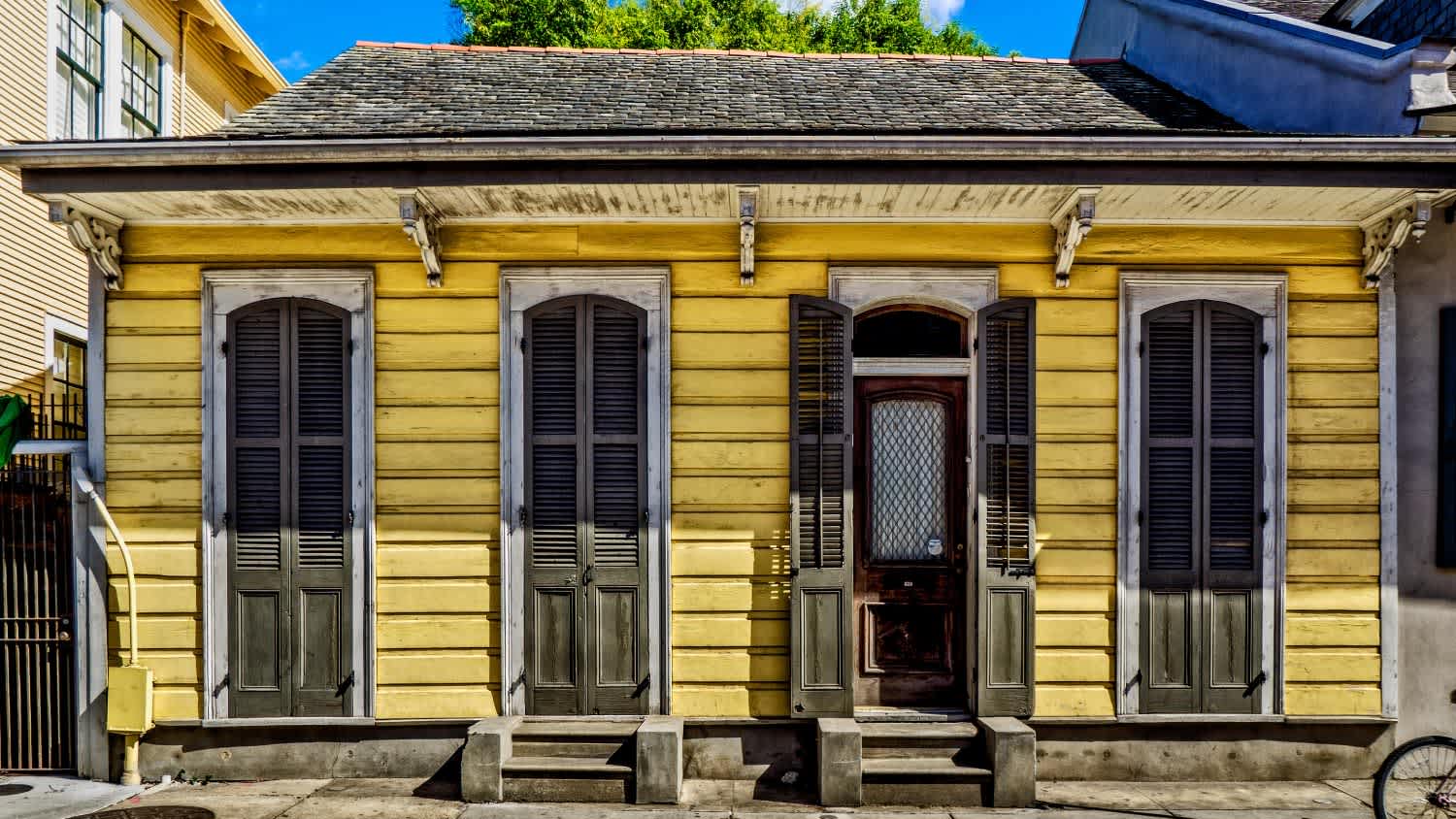 A yellow shotgun house
