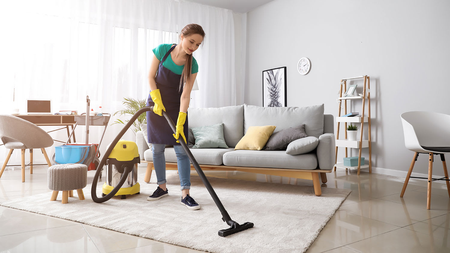 Woman using vacuum cleaner in the living room