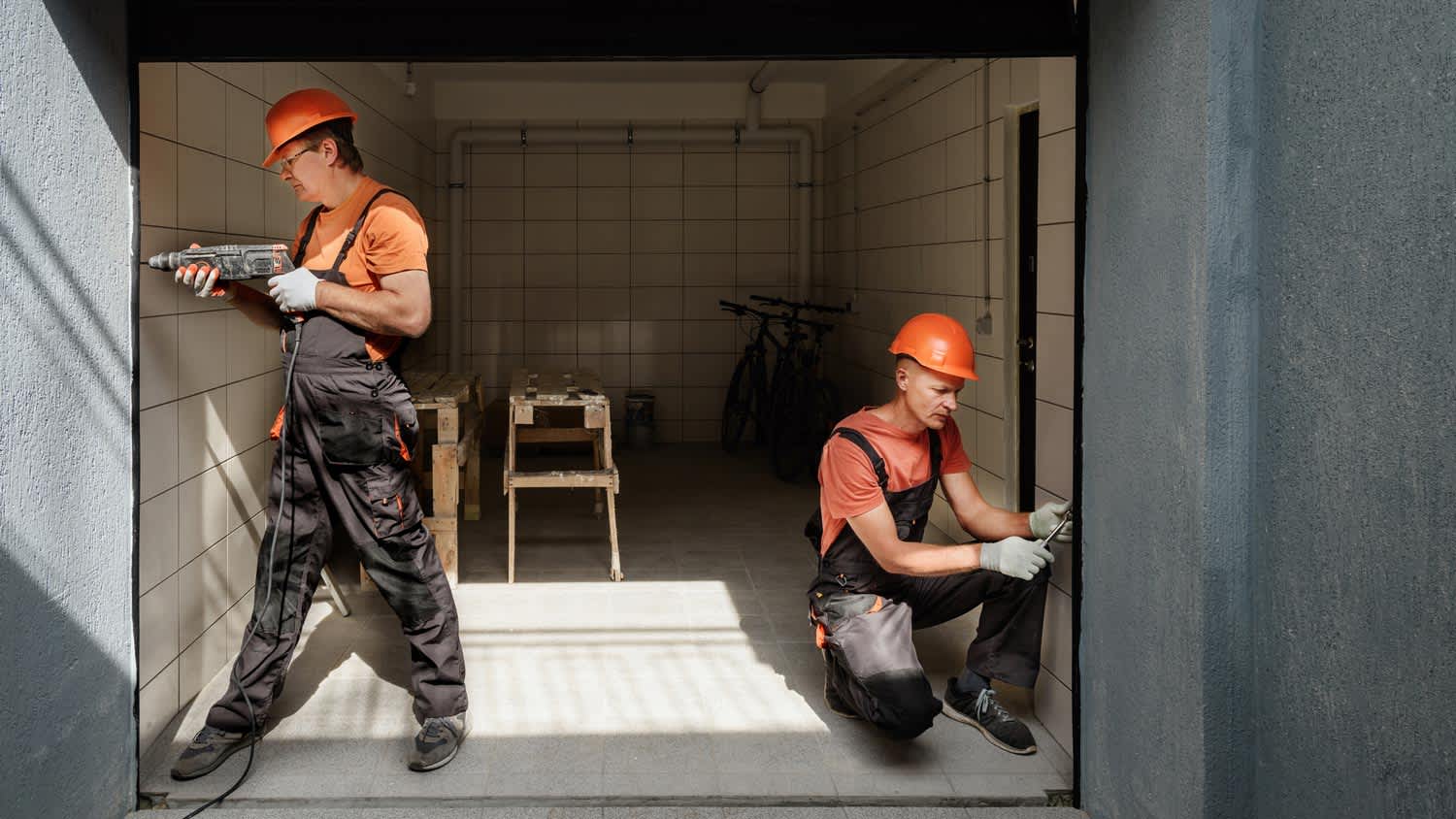 Two workers installing a garage door