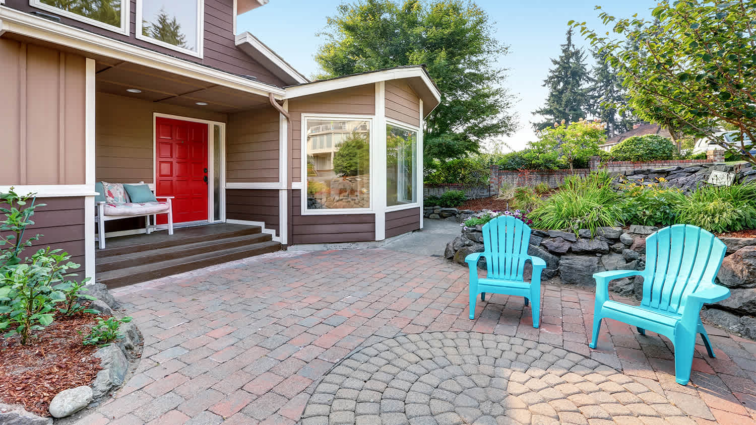 blue chairs in yard on whorled paver
