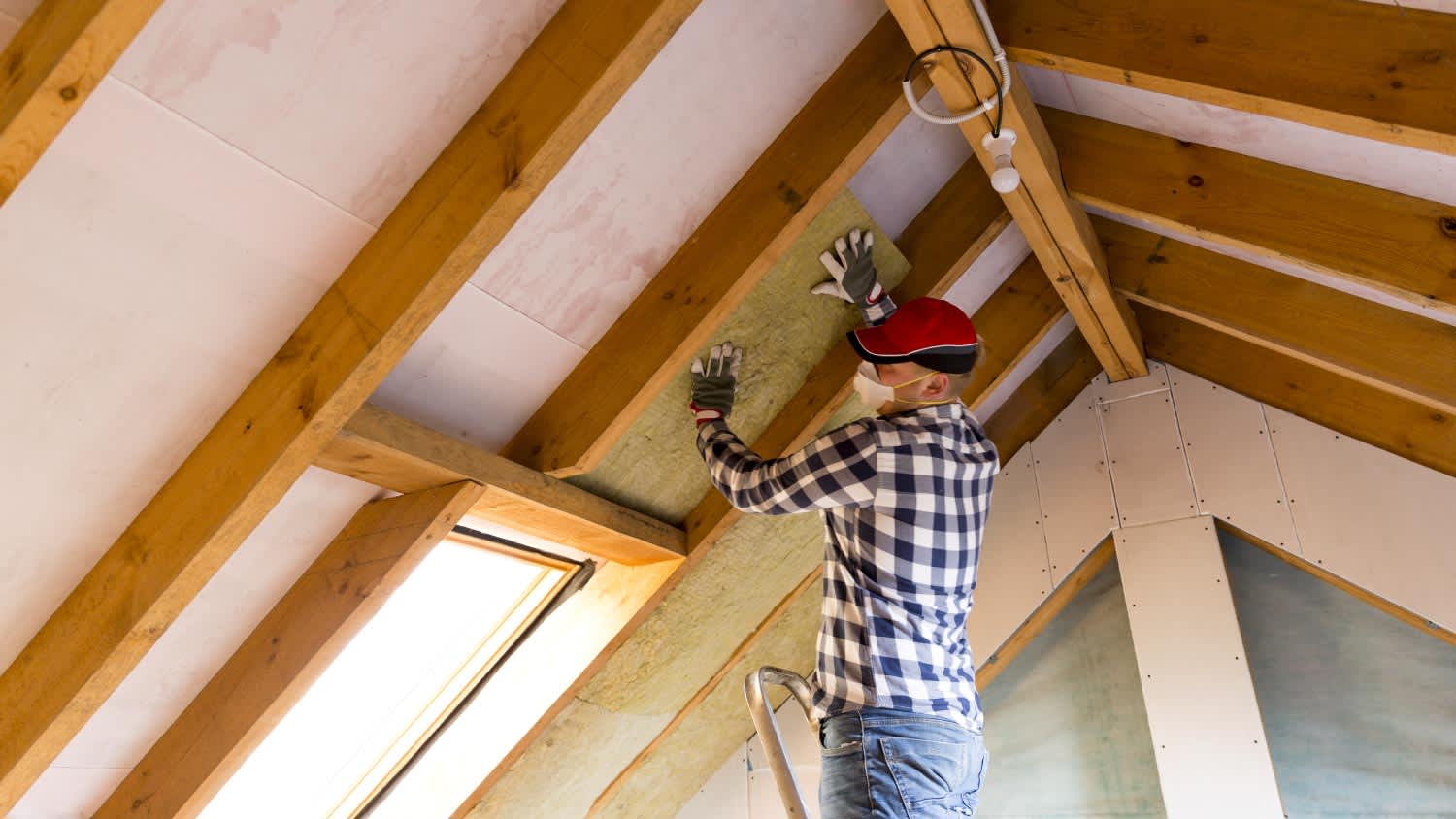 Man installing roof shingles
