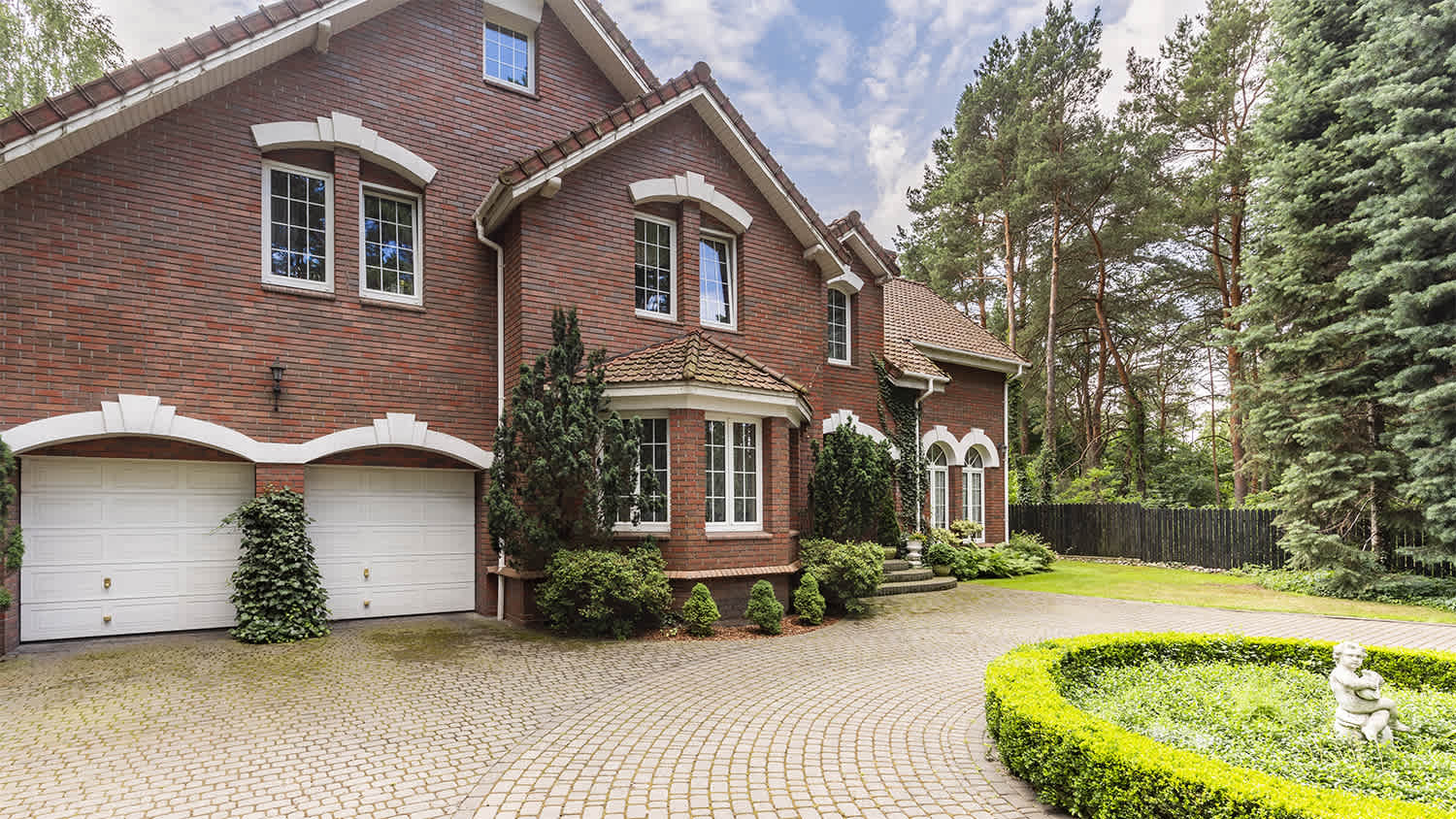 large brown house with brick pathway