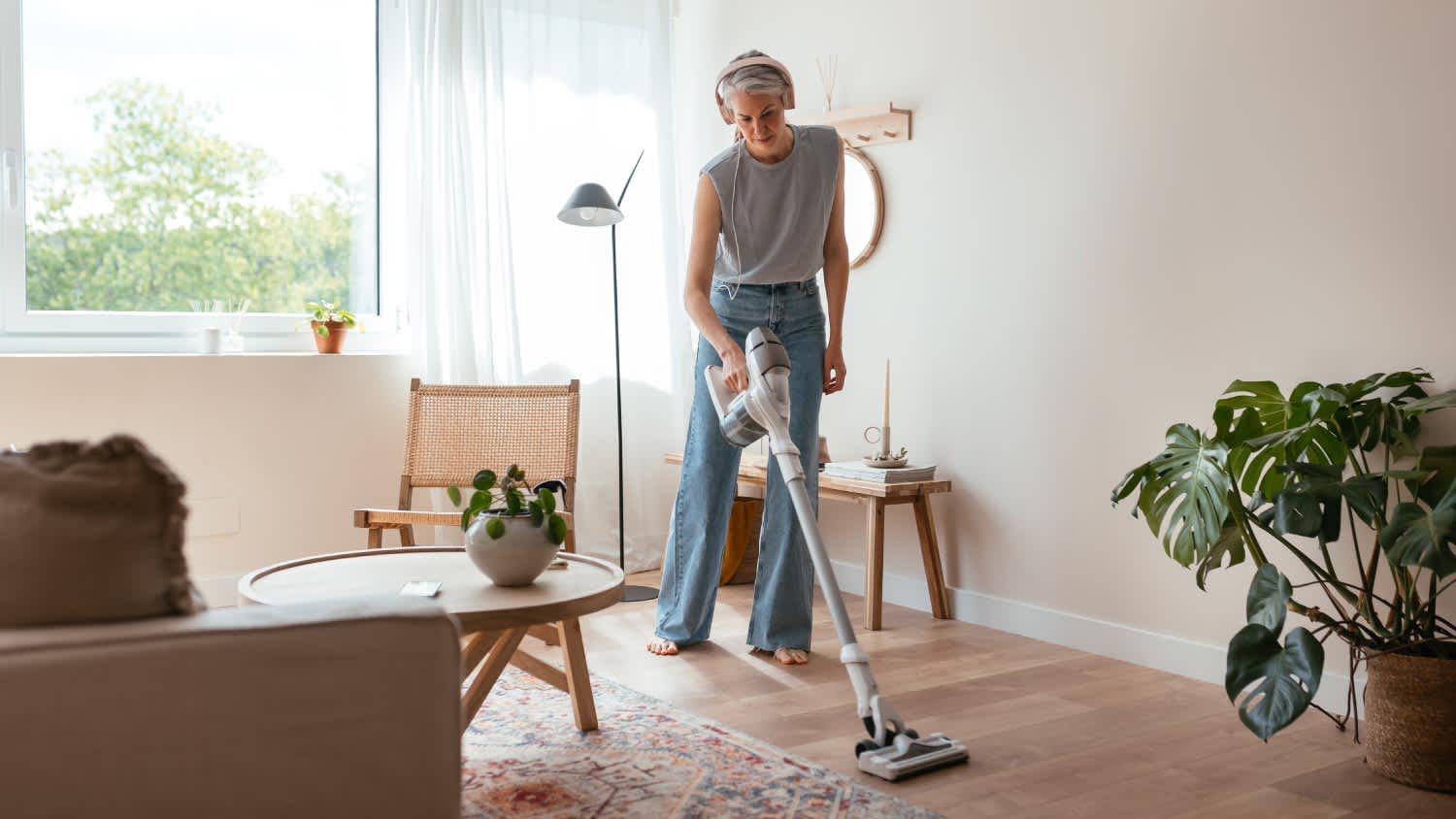 Housewife cleaning floor in living room